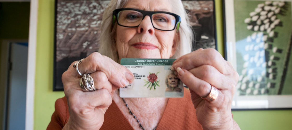Older woman holding drivers license - DCJ Housing image - Seniors Strategy