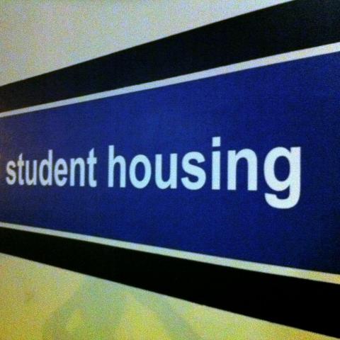 Student housing sign, white text against blue background on wall Credit: @billsoPHOTO