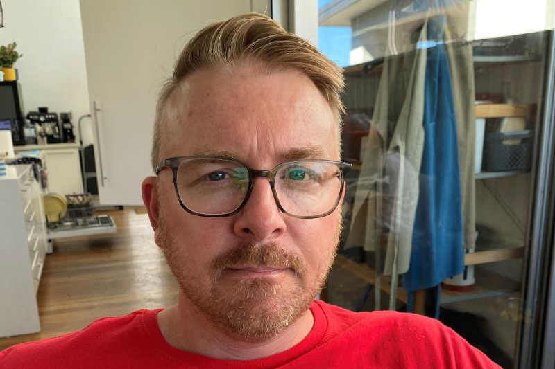 Richard, white male with glasses, beard, blue eyes wearing a red t-shirt.