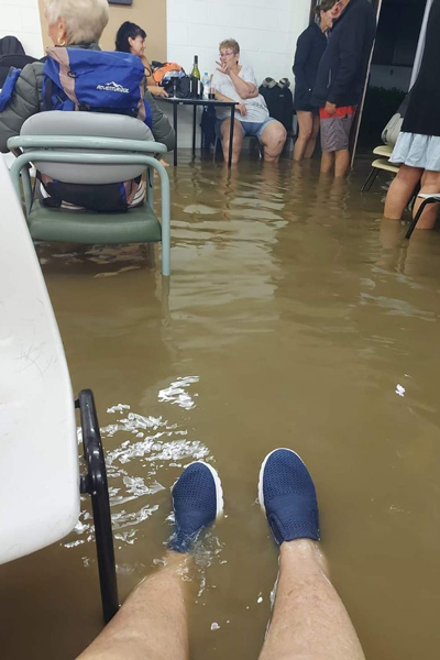 residents waiting to be rescued, with their feet in the flood water