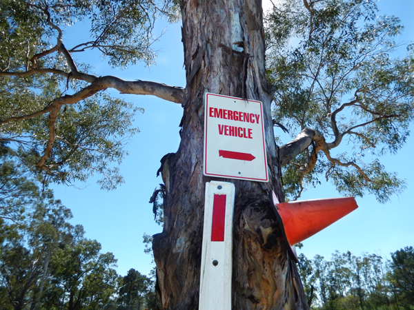 Emergency access signage in the reserve pointing the way to Wallacia Caravan Park